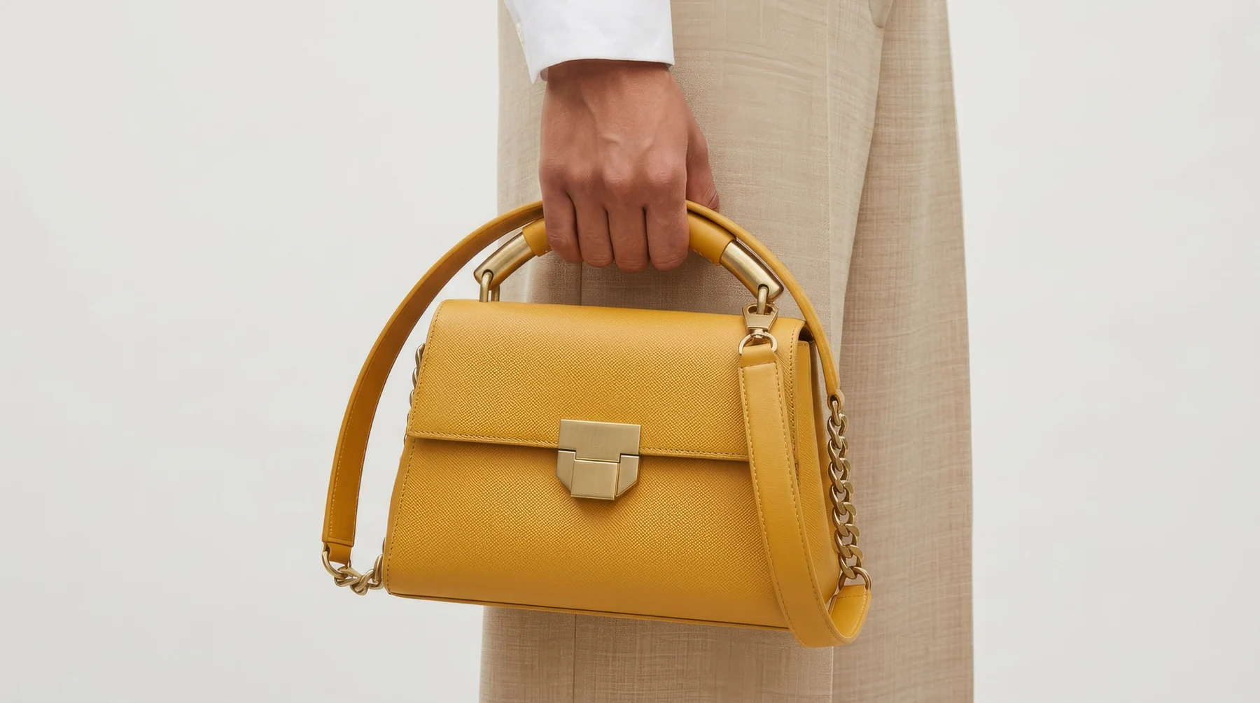 Mustard leather handbag product detail with gold hardware