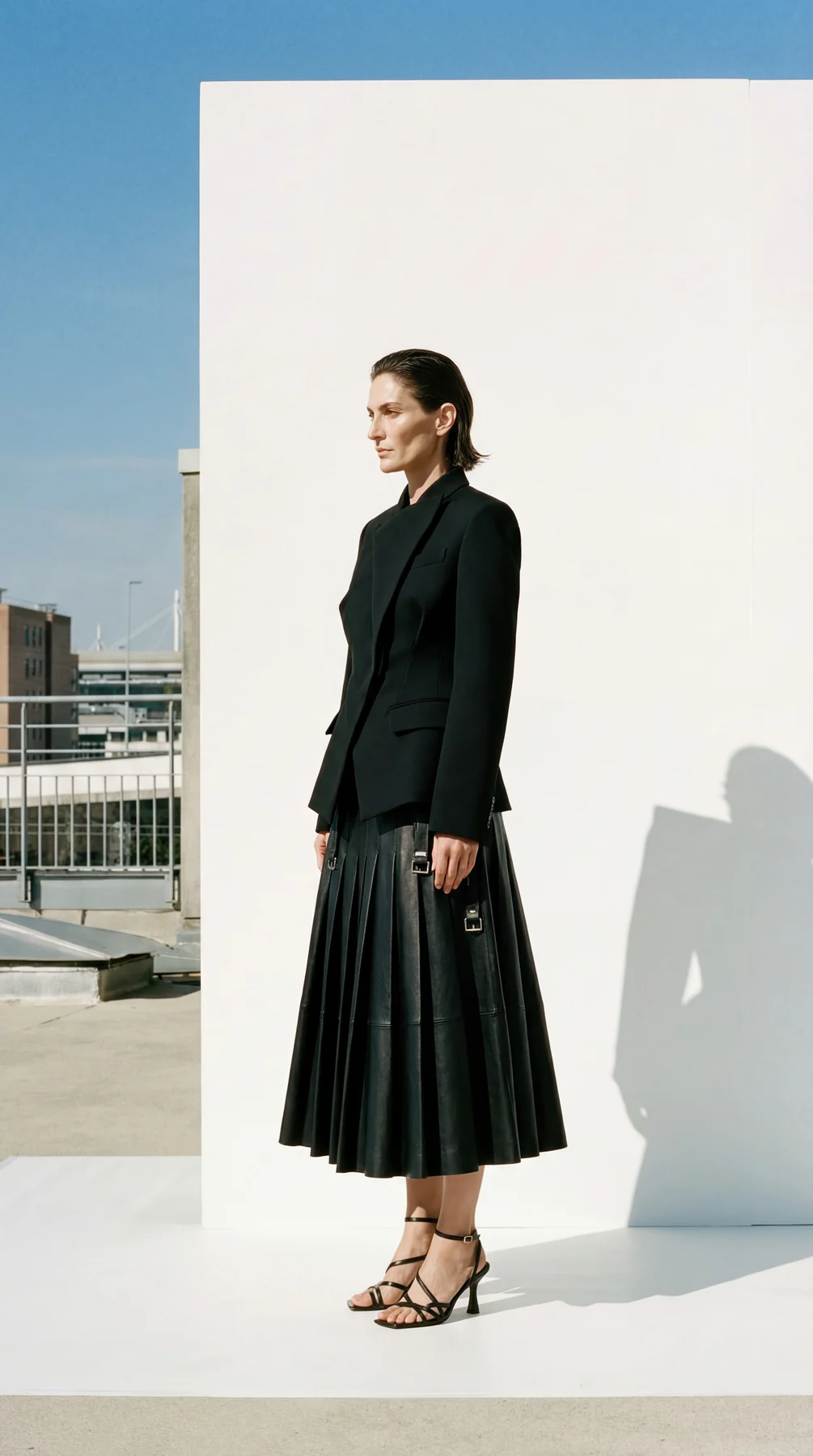 Minimal black tailoring portrait in architectural light